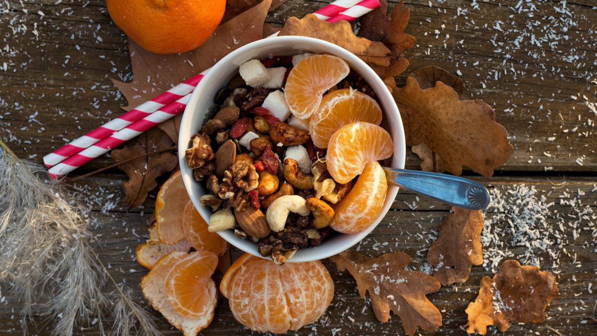 saisonale lebensmittel im winter weihnachtliches arrangement mit nüssen und mandarinen