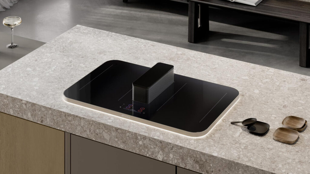 smeg isola kochfeld mit dunstabzug und runden ecken in einer dicken steinarbeitsplatte von oben